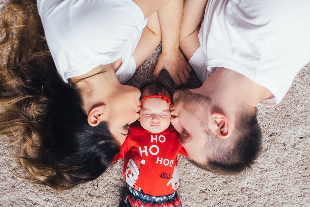 Happy couple holding their baby after a successful IVF journey